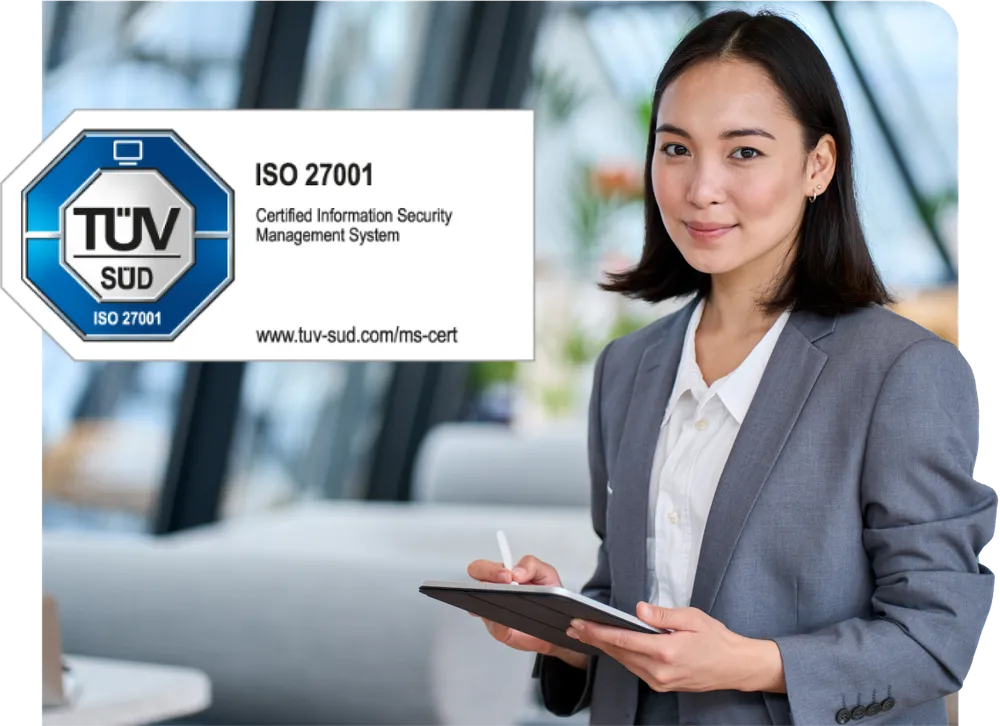 Businesswoman in a gray suit holding a tablet, standing next to an ISO 27001 certification sign for information security management.